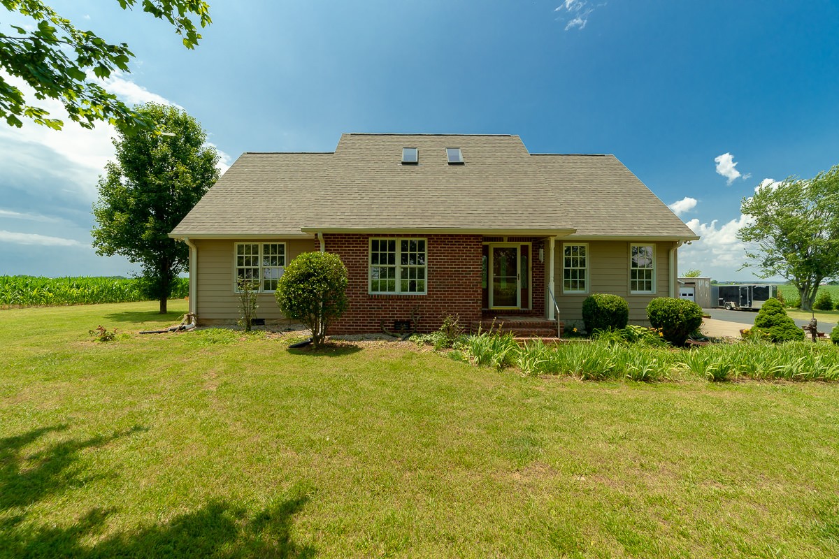 a view of a house with swimming pool and a yard