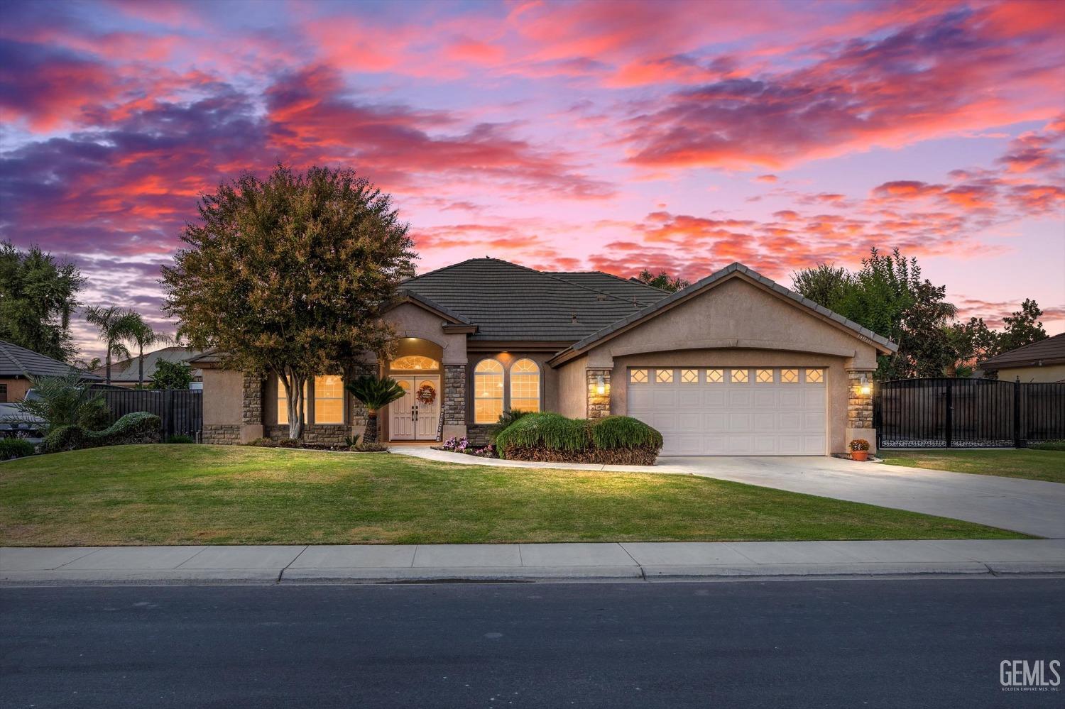 a front view of a house with a yard and a garage