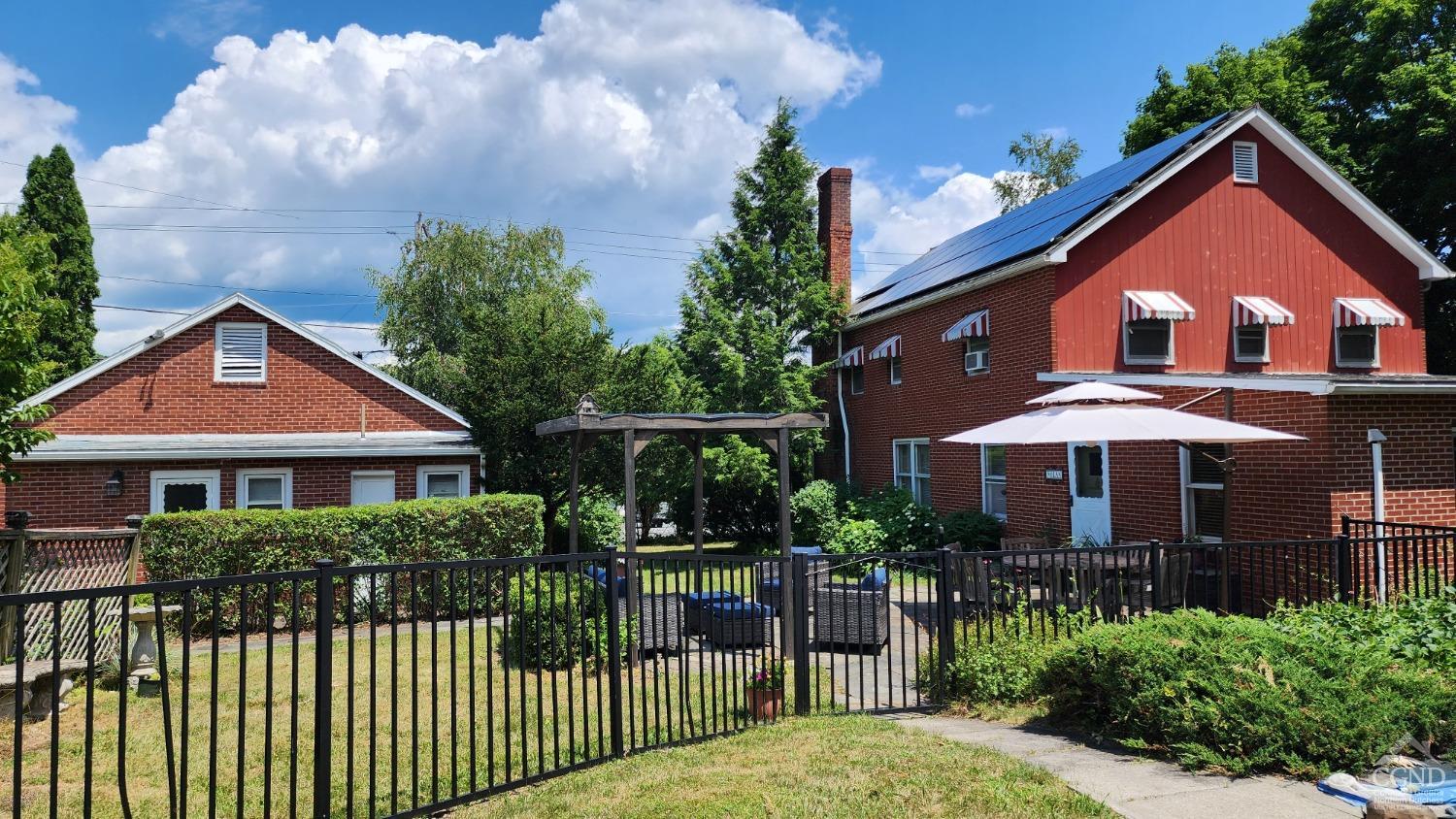 a front view of a house with garden