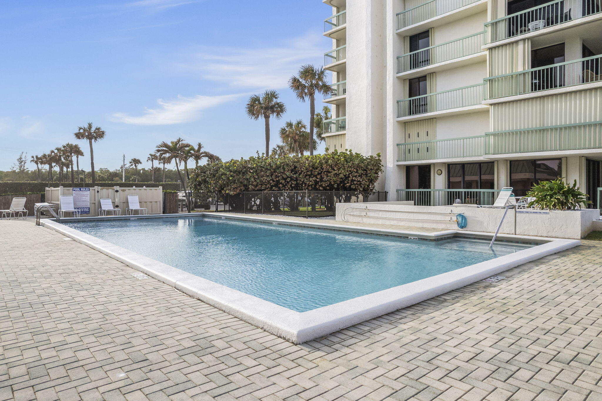 a view of a swimming pool with a chair