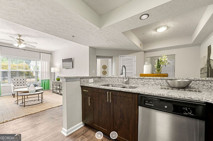 a living room with granite countertop kitchen island furniture and a wooden floor