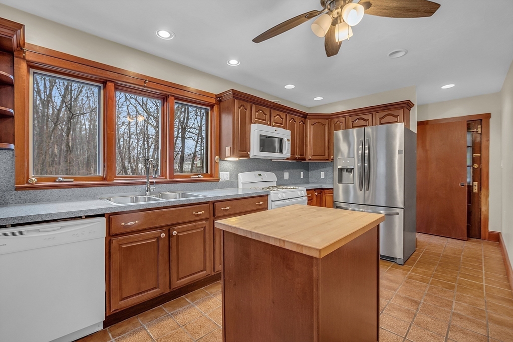 a kitchen that has a lot of cabinets in it and stainless steel appliances