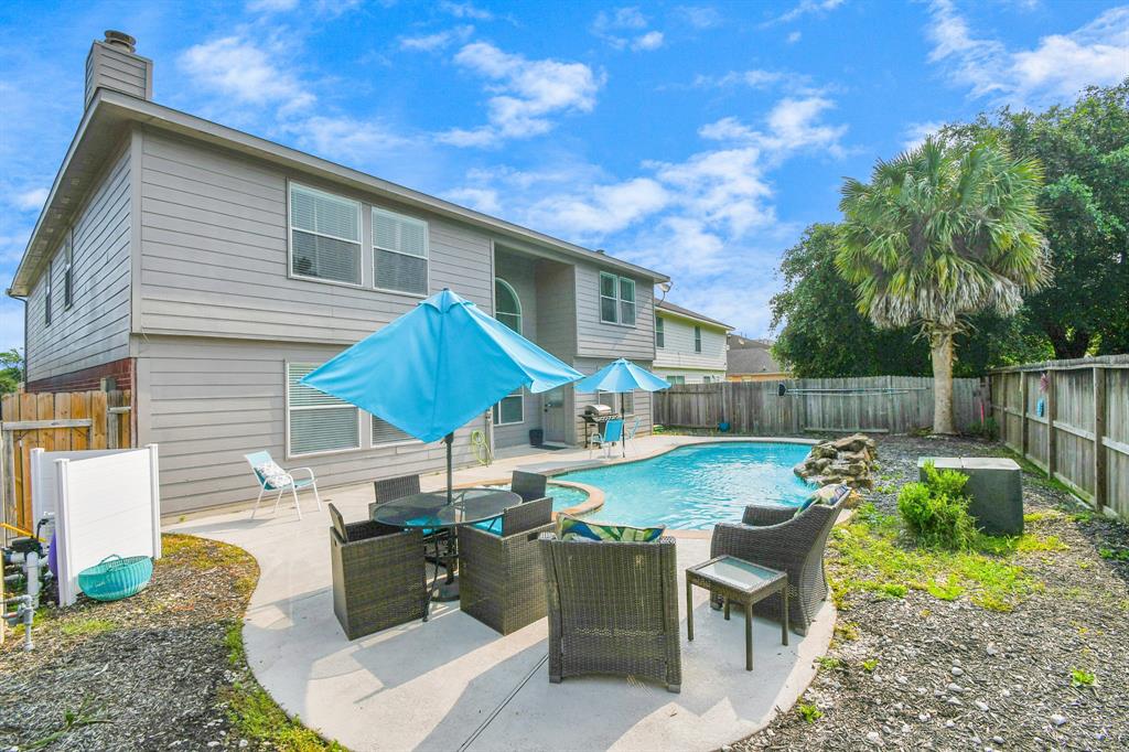 a view of backyard of house with seating space