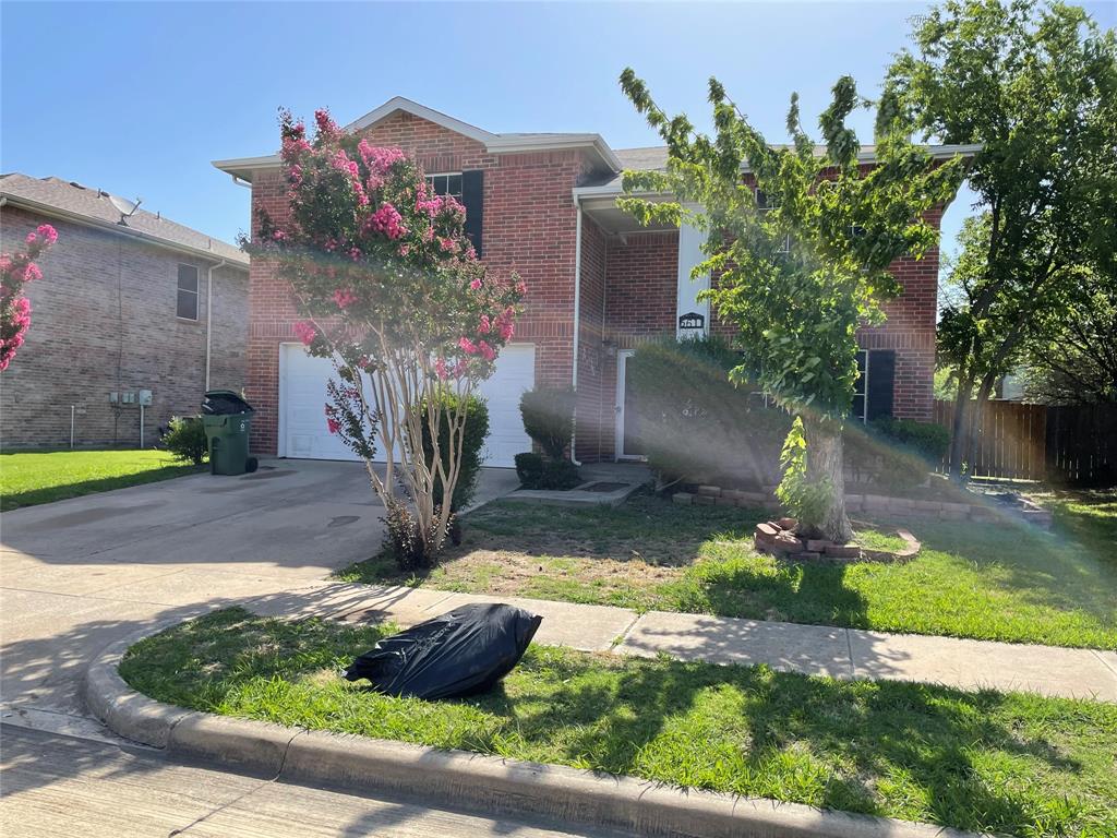 a front view of a house with yard