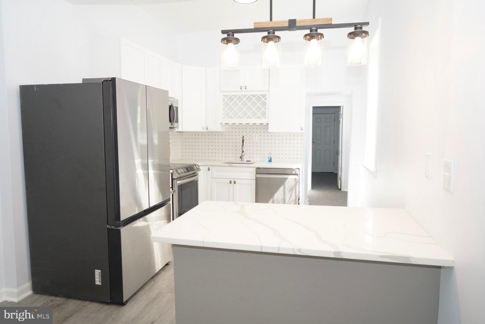 a kitchen with a refrigerator and a sink