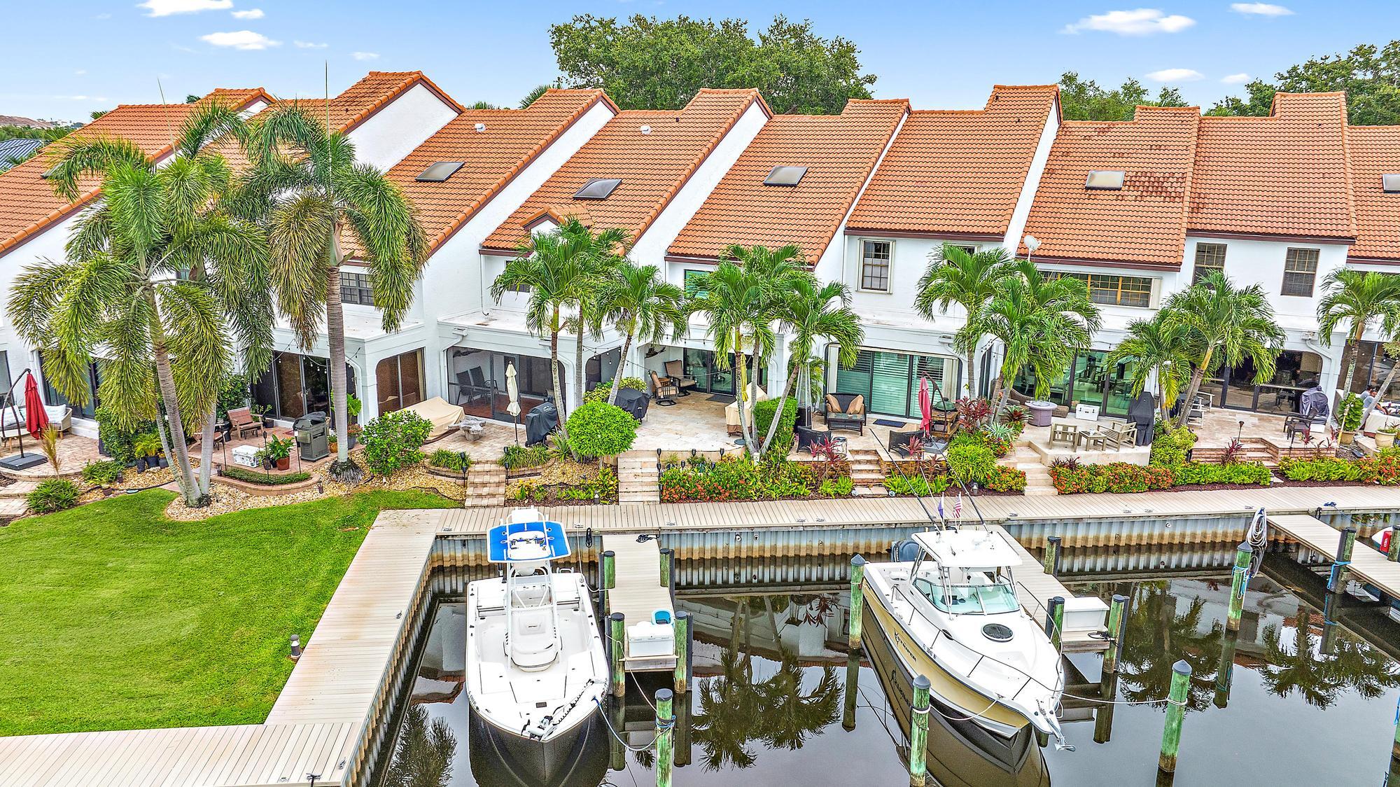 an aerial view of a house with garden space and swimming pool