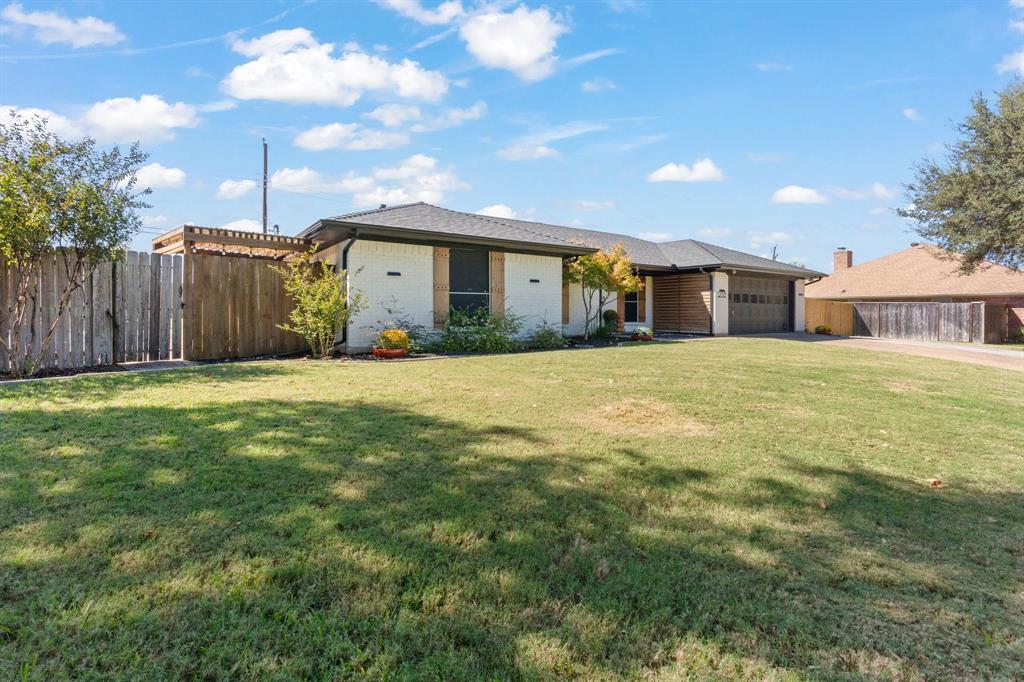 a view of a house with a yard and garage