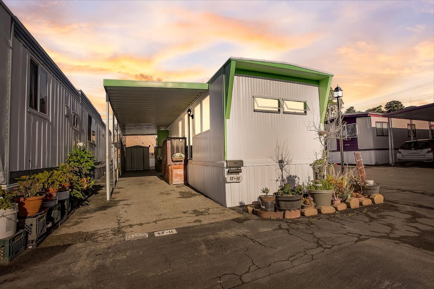 a view of backyard with wheel chair potted plants and wooden fence