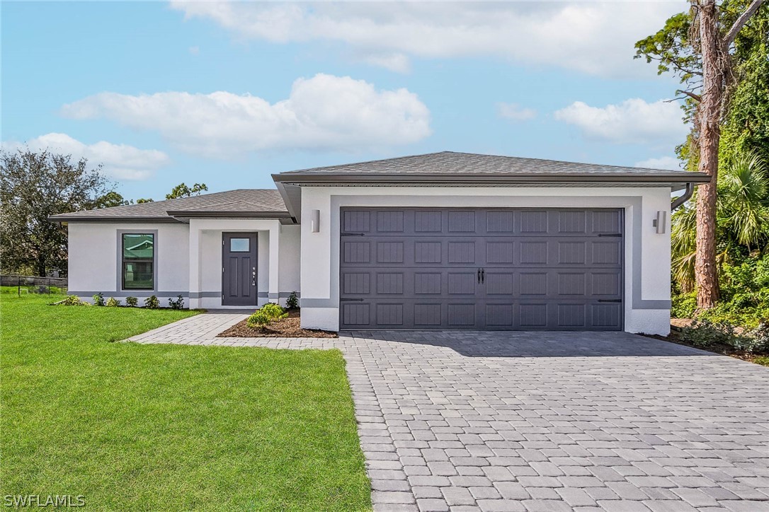 a front view of a house with a yard and garage