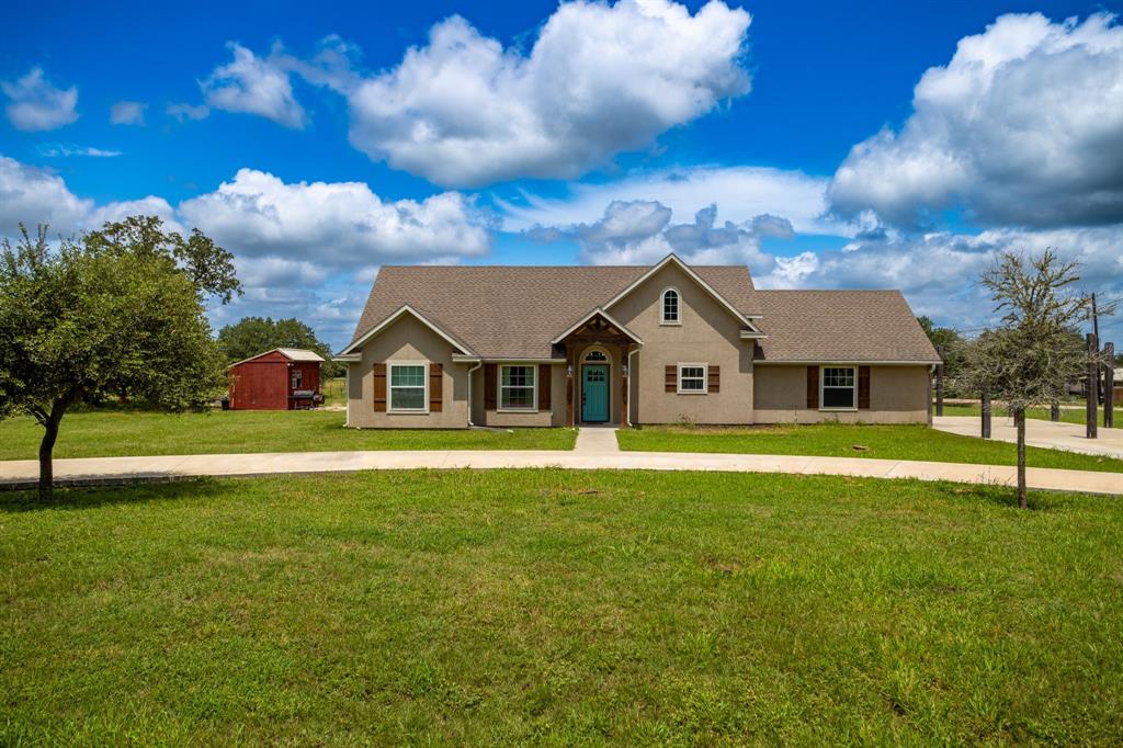 a front view of house with yard and green space