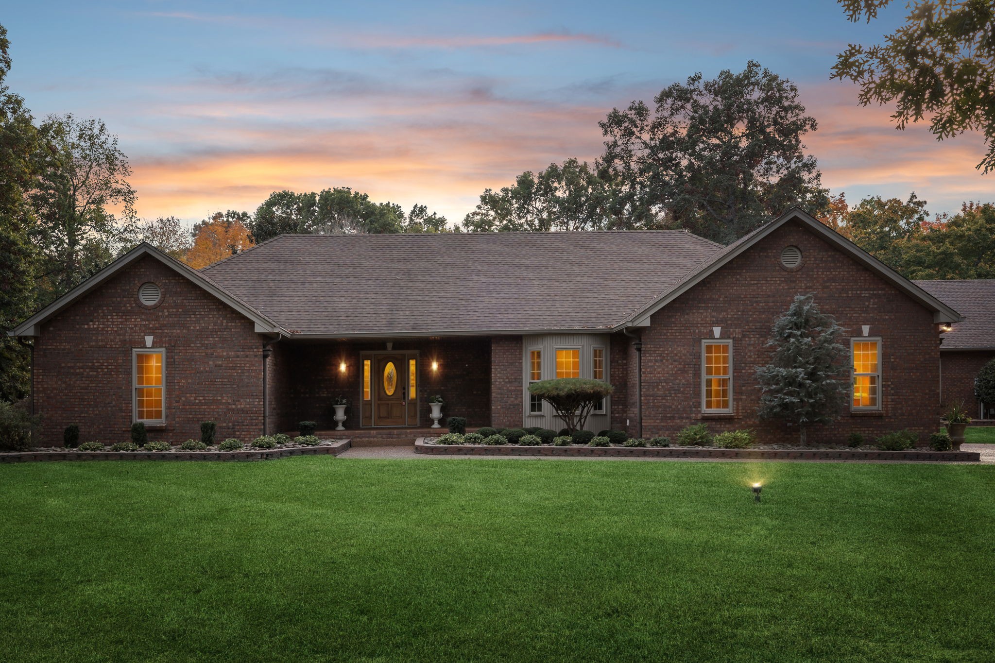 a front view of house with yard and green space