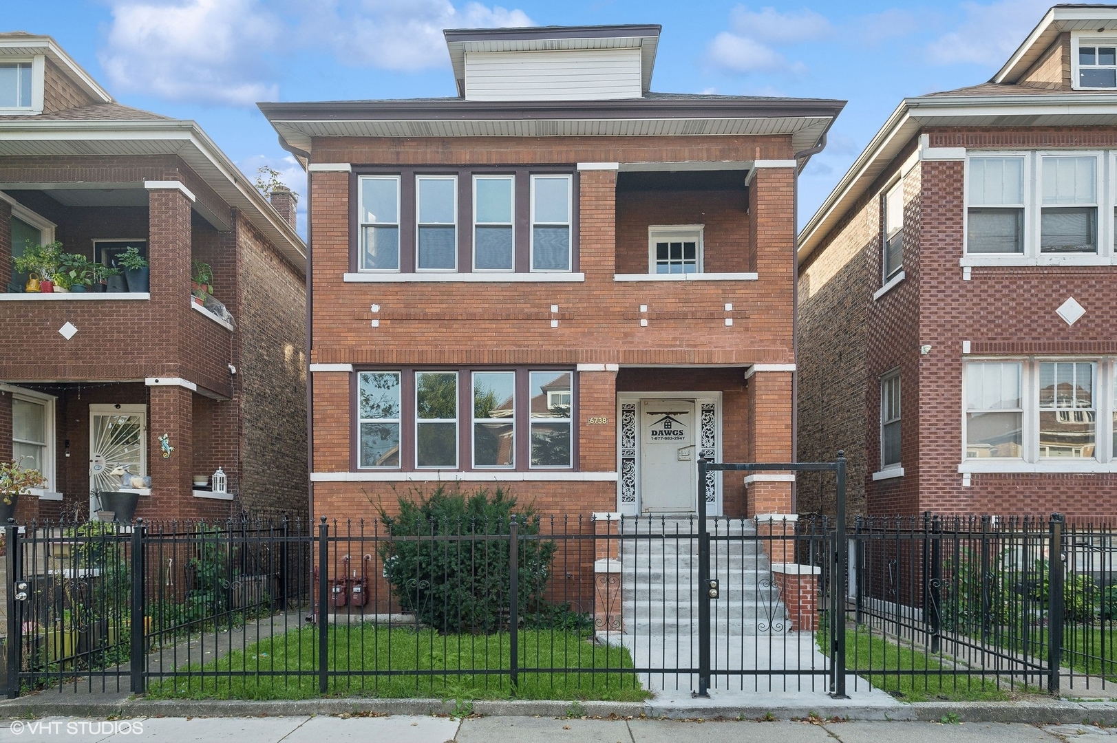 a view of a brick building next to a yard