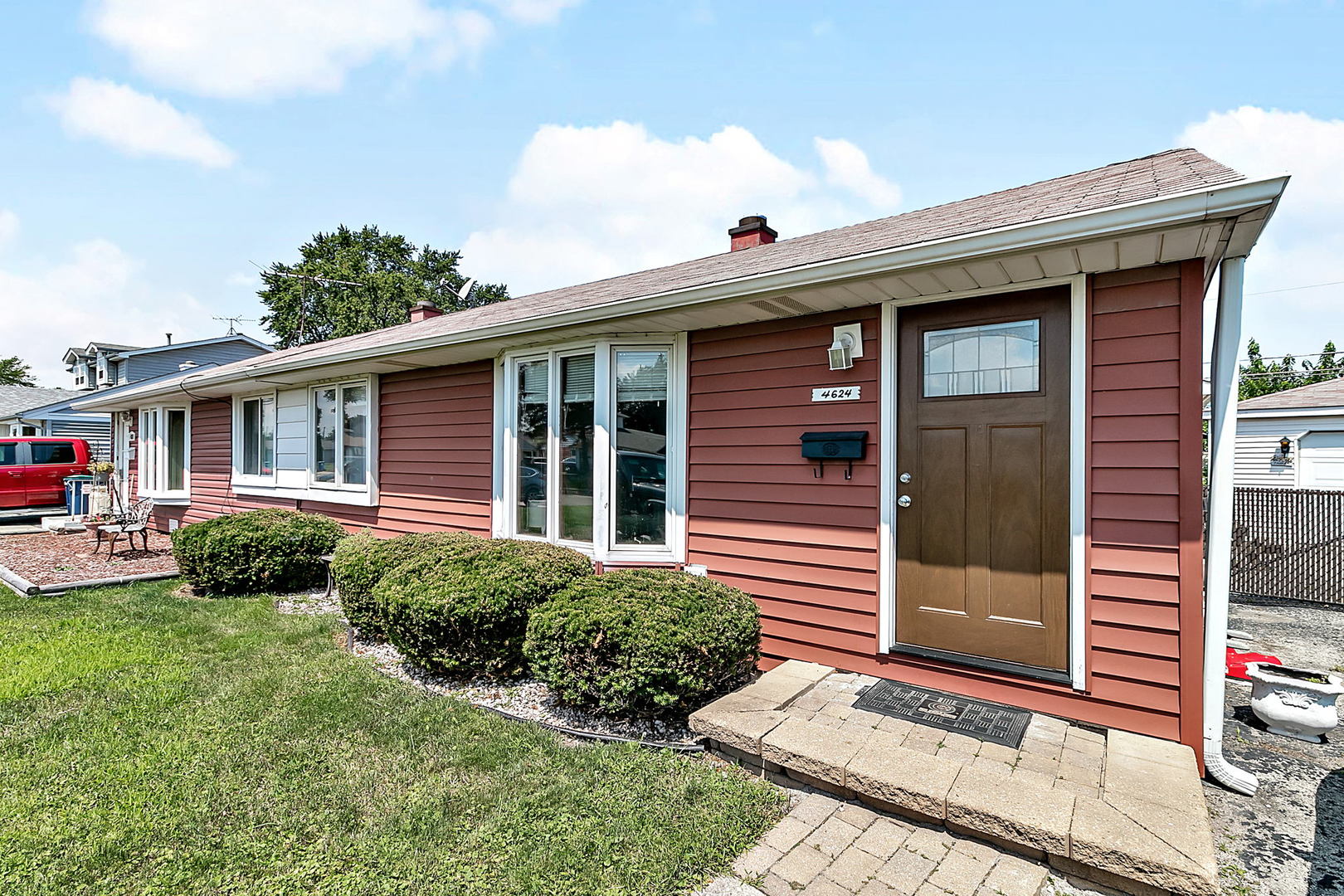 a view of a house with a yard and plants