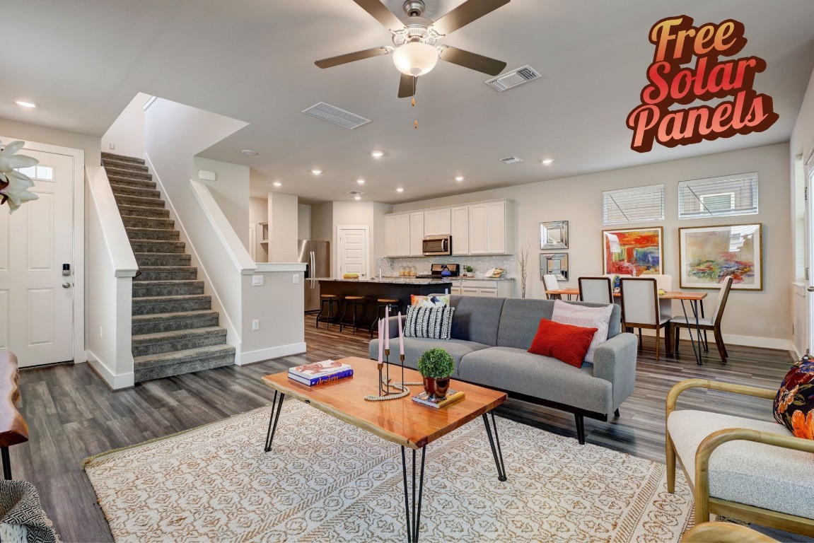 a living room with furniture kitchen view and a table