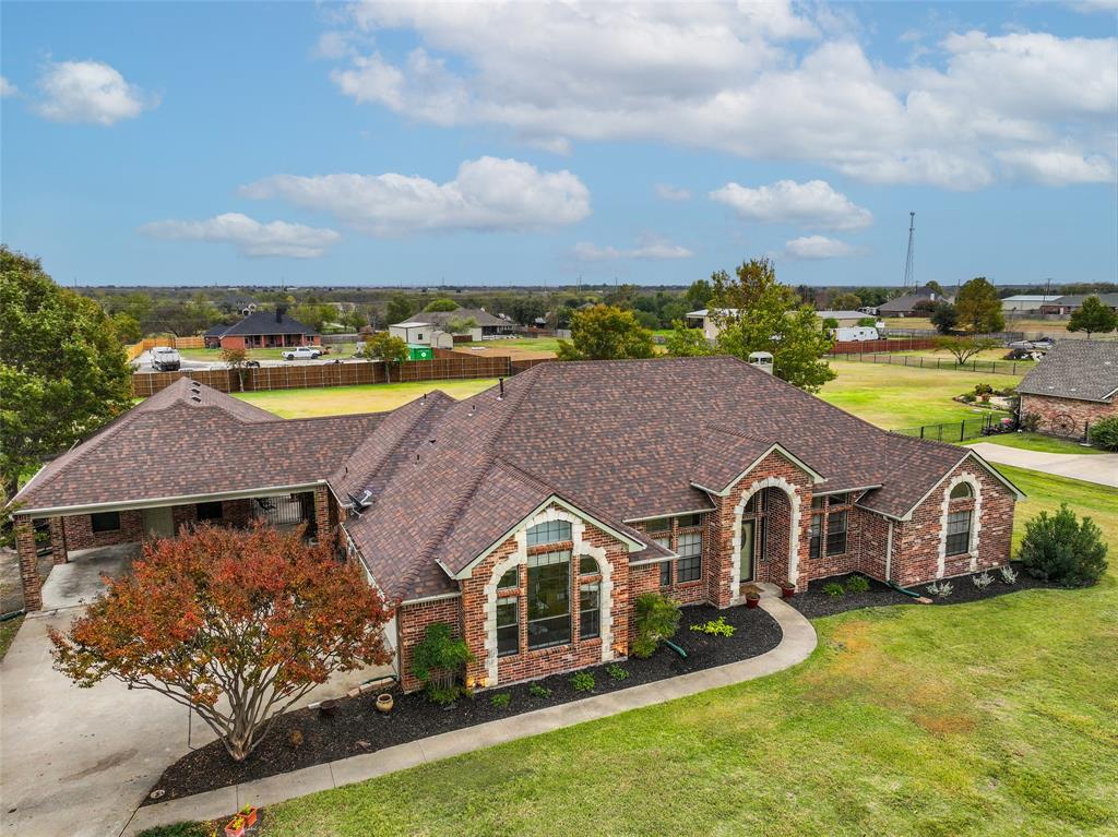 an aerial view of a house with swimming pool and lake view