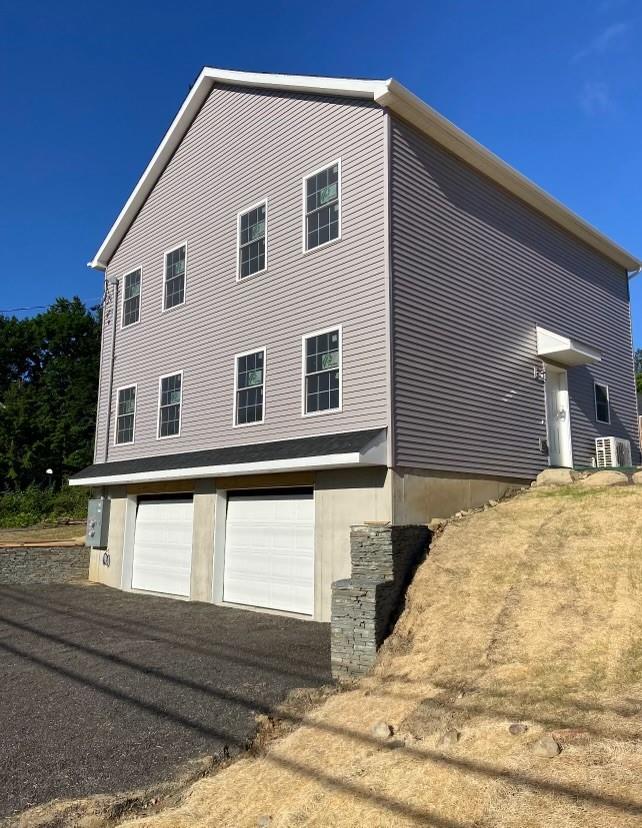 View of property exterior featuring a garage