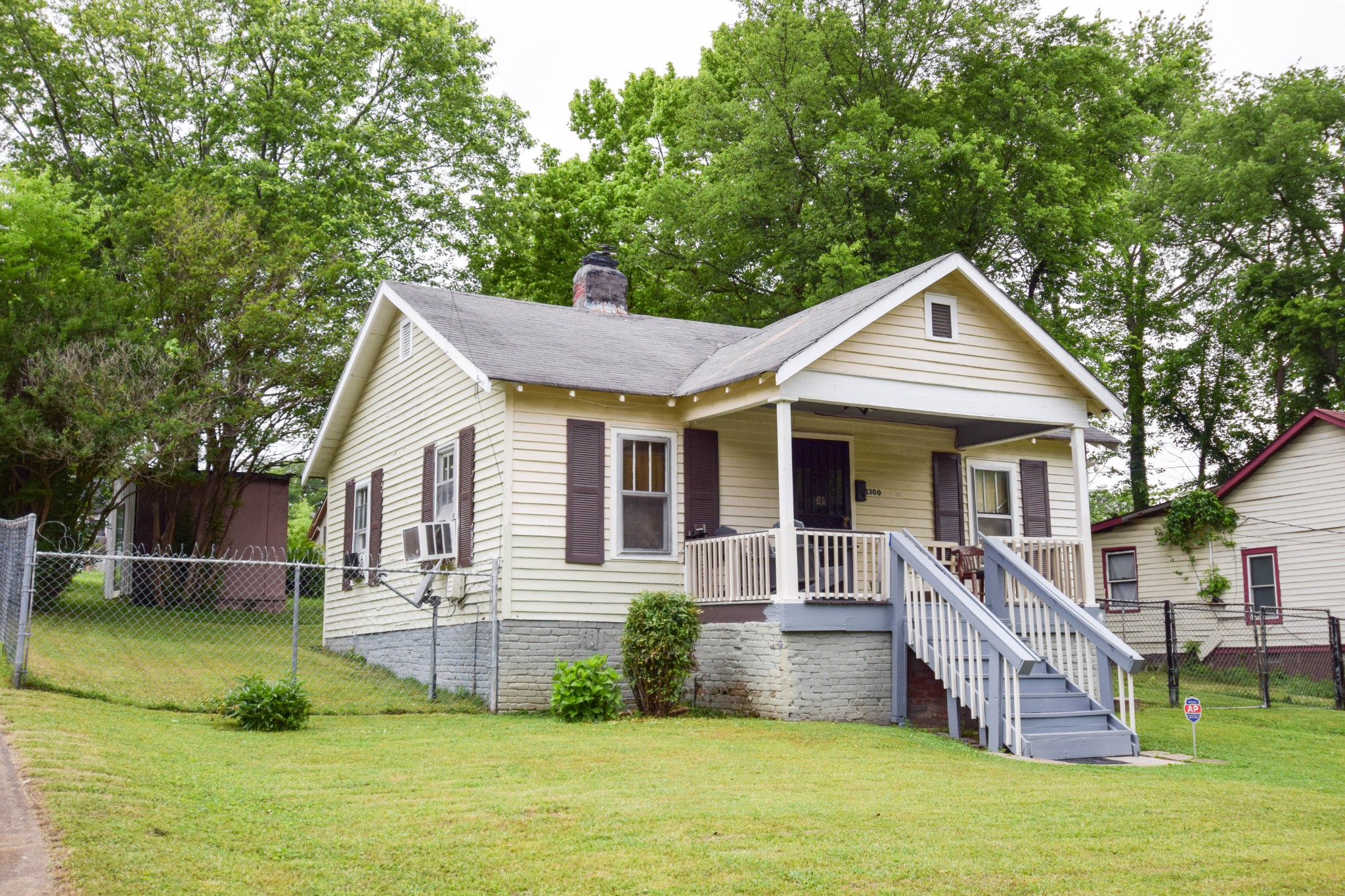 a front view of a house with a yard table and chairs