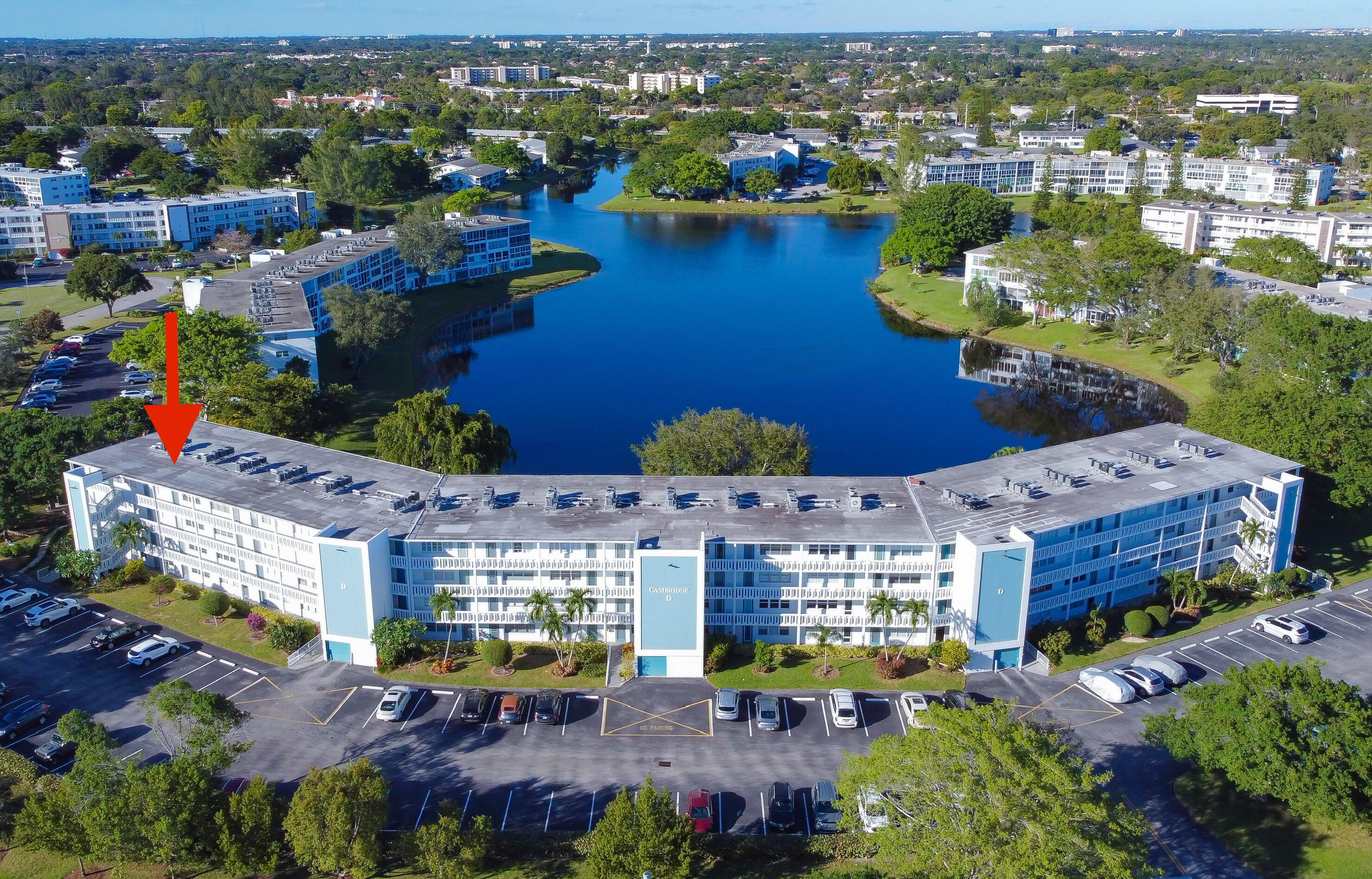 an aerial view of a houses with a lake