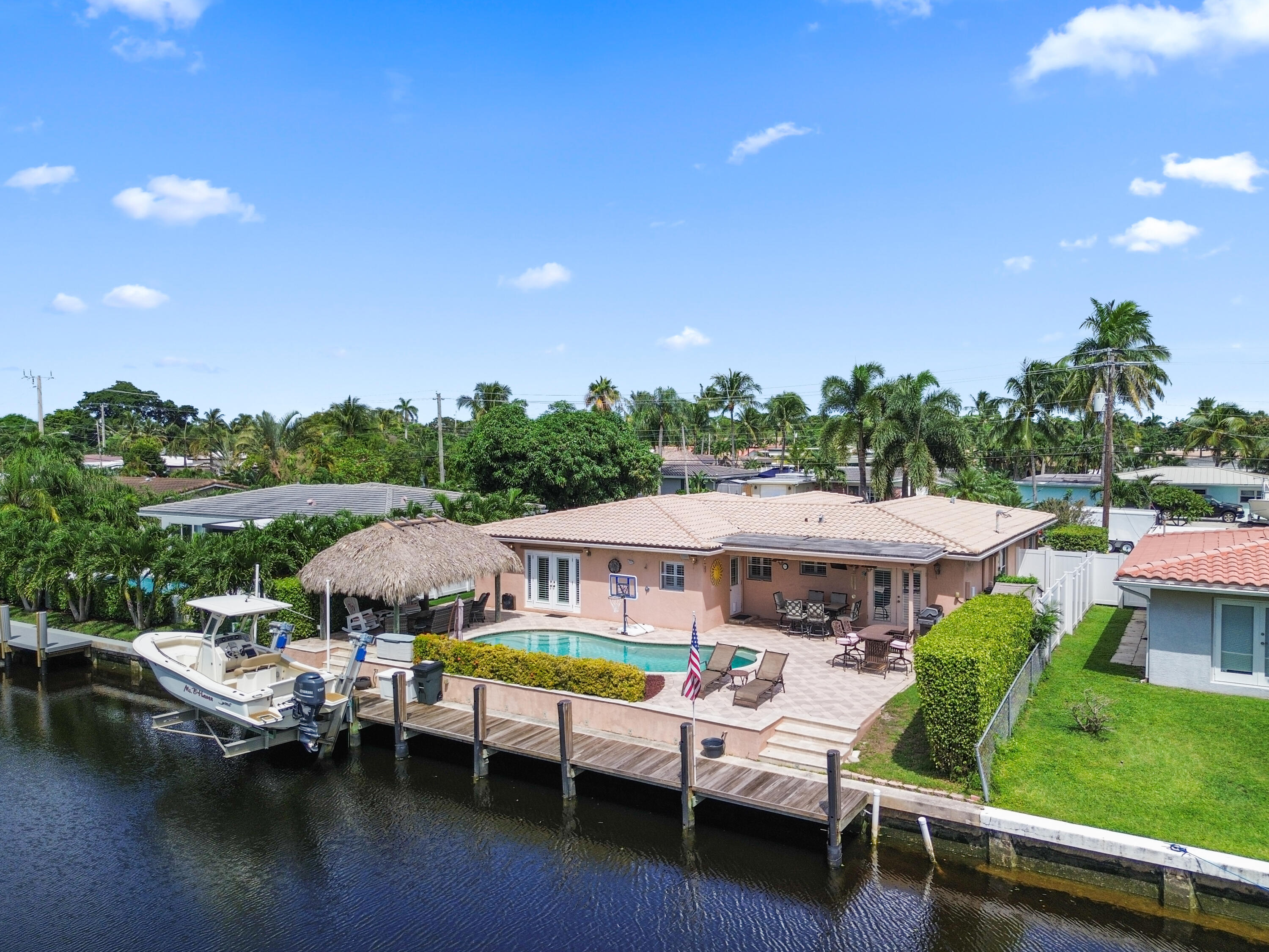 a view of house with swimming pool outdoor seating area and lake view