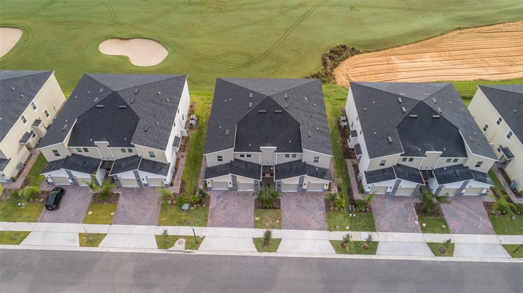 an aerial view of residential houses with outdoor space