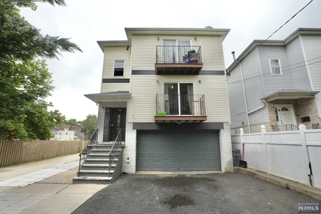 a view of a house with more windows and wooden fence