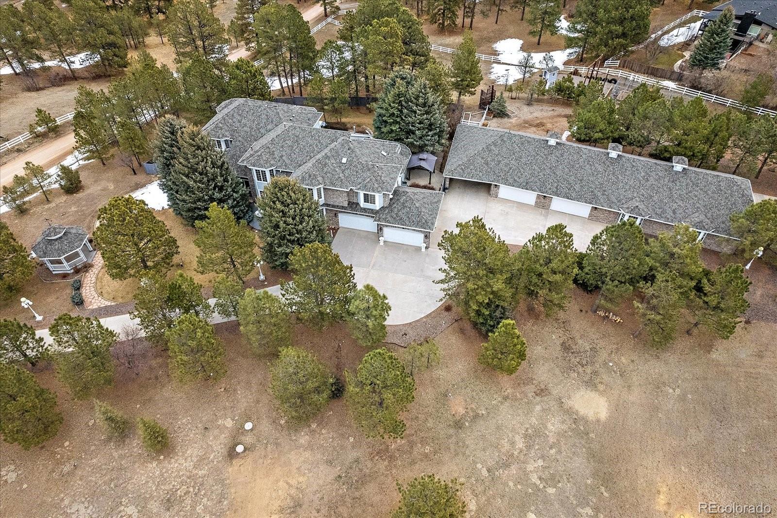 an aerial view of a house with a yard