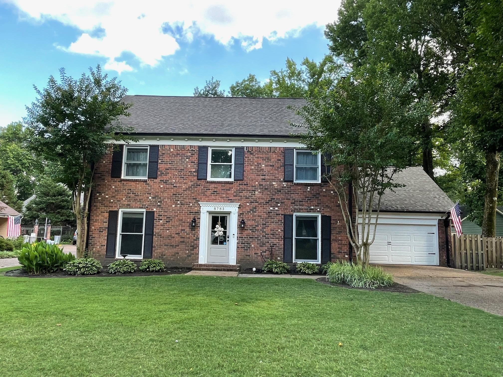 front view of a house with a yard