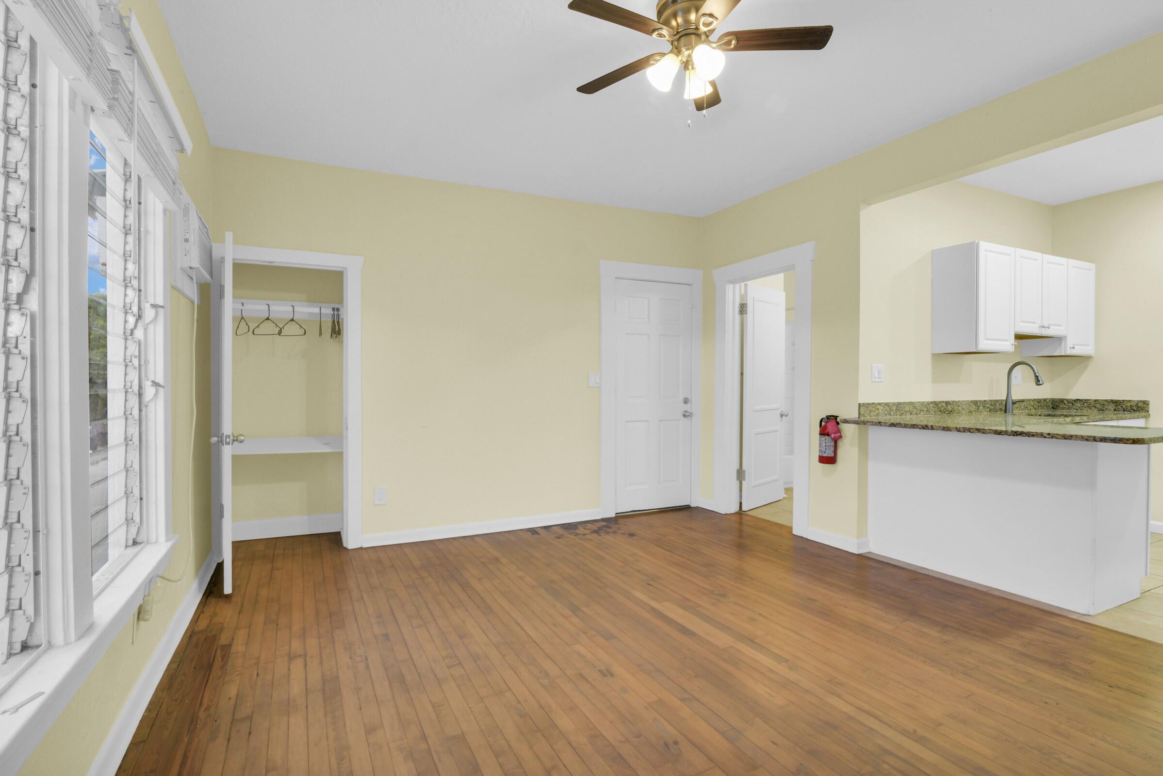 a view of kitchen with granite countertop cabinets and wooden floor