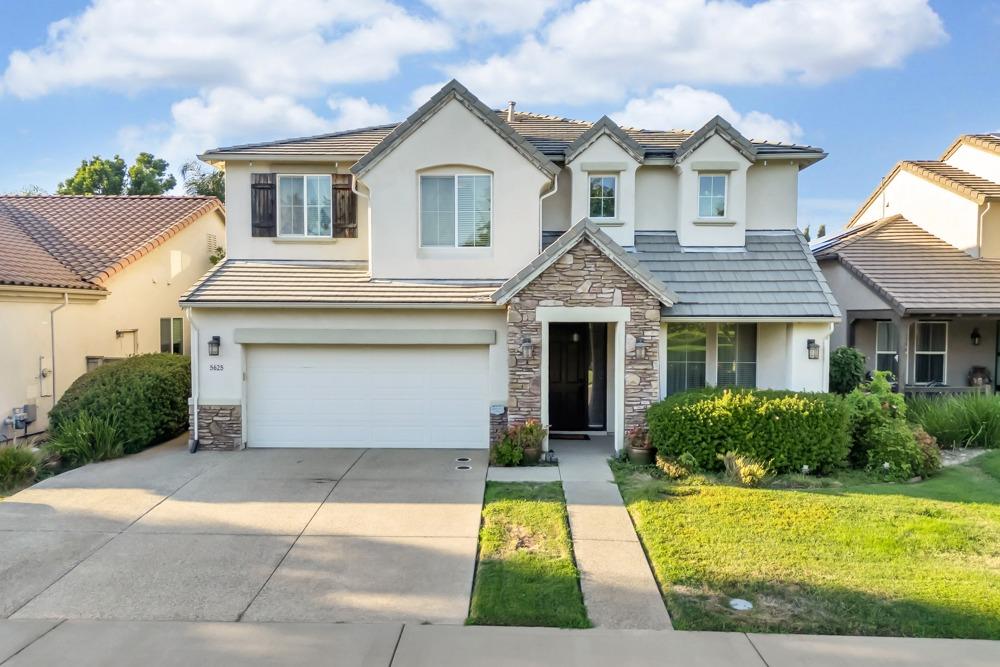 a front view of a house with yard