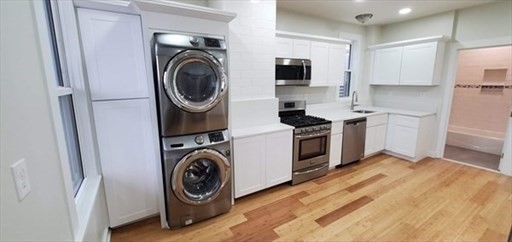 a utility room with sink dryer and washer