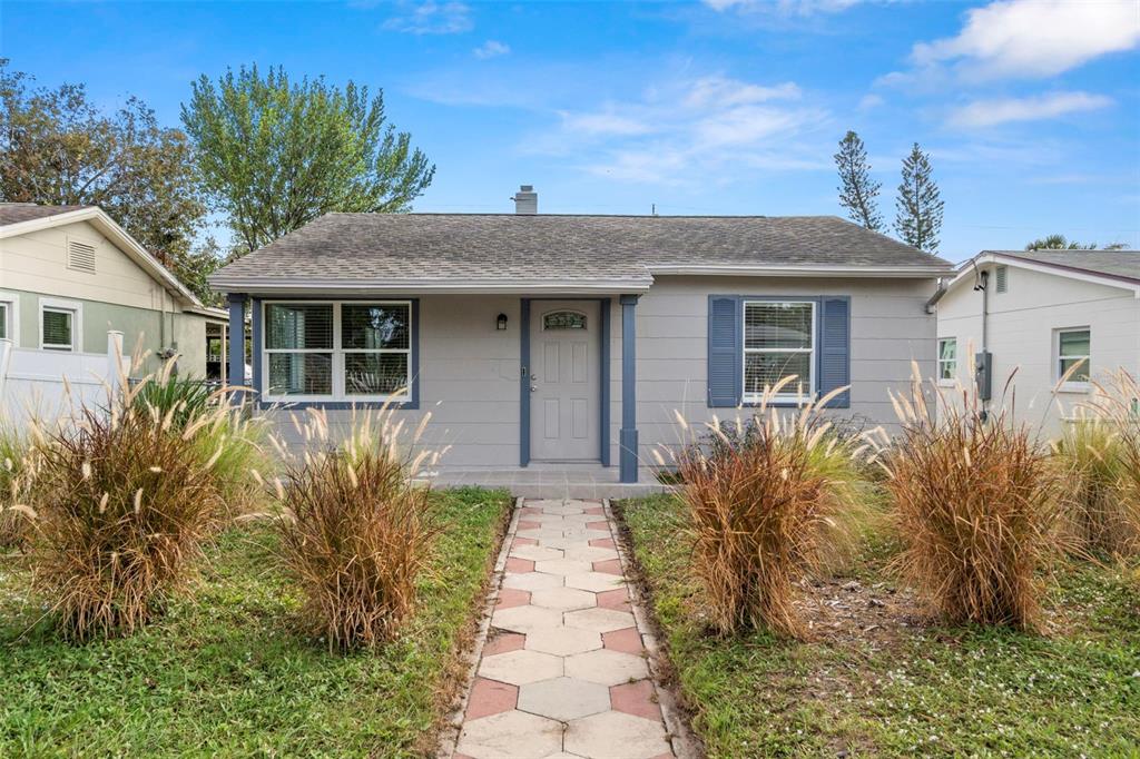 a front view of house with yard and trees around