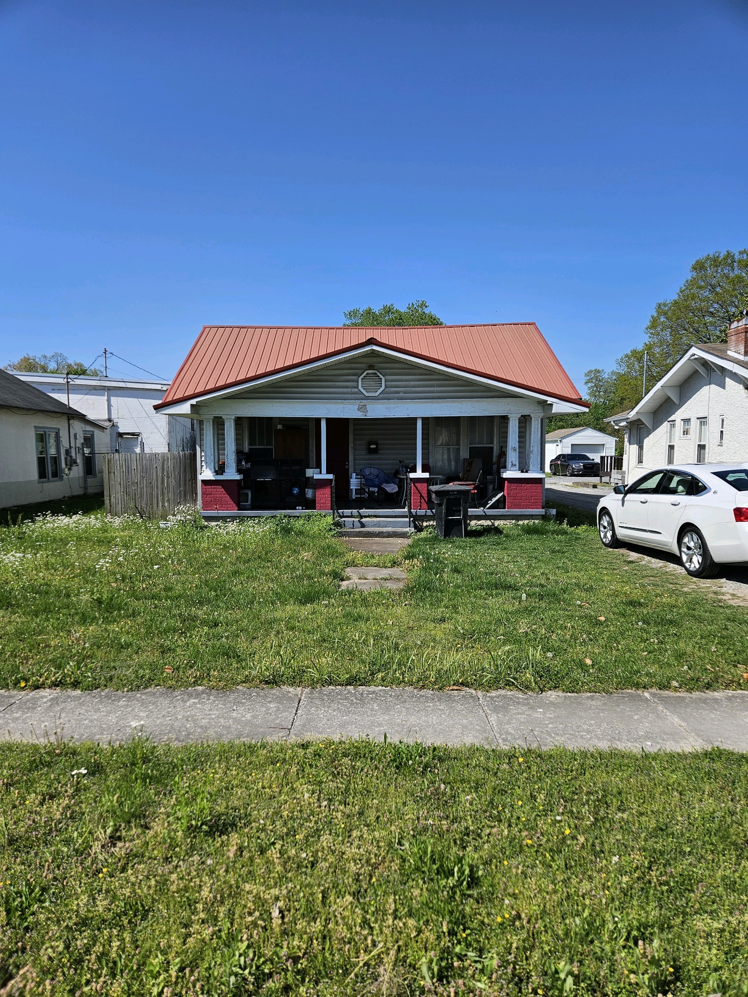 a front view of a house with a yard table and chairs