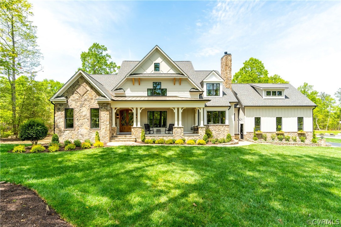 a front view of a house with garden and trees