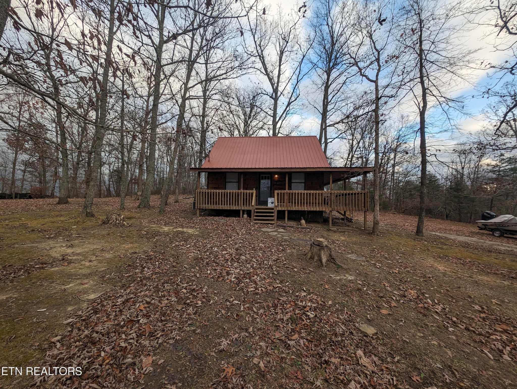 a view of a house with backyard and a tree