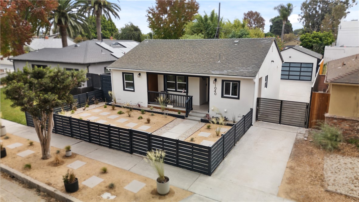 a view of house with backyard and trees