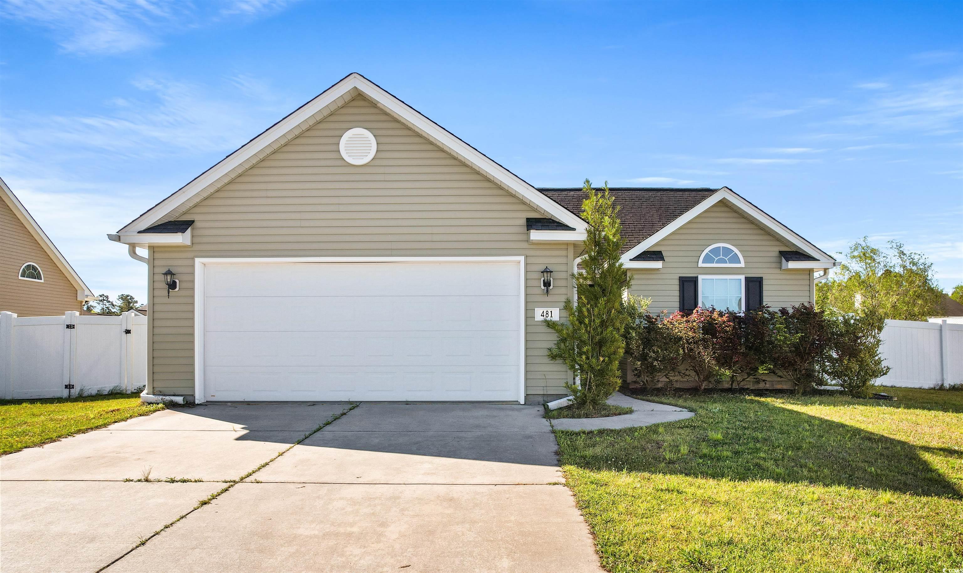 View of front of property featuring a garage and a