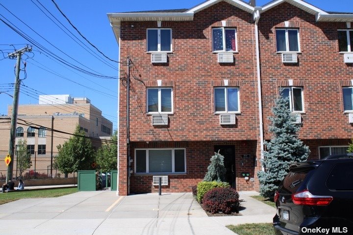 a view of a brick house with many windows and a table