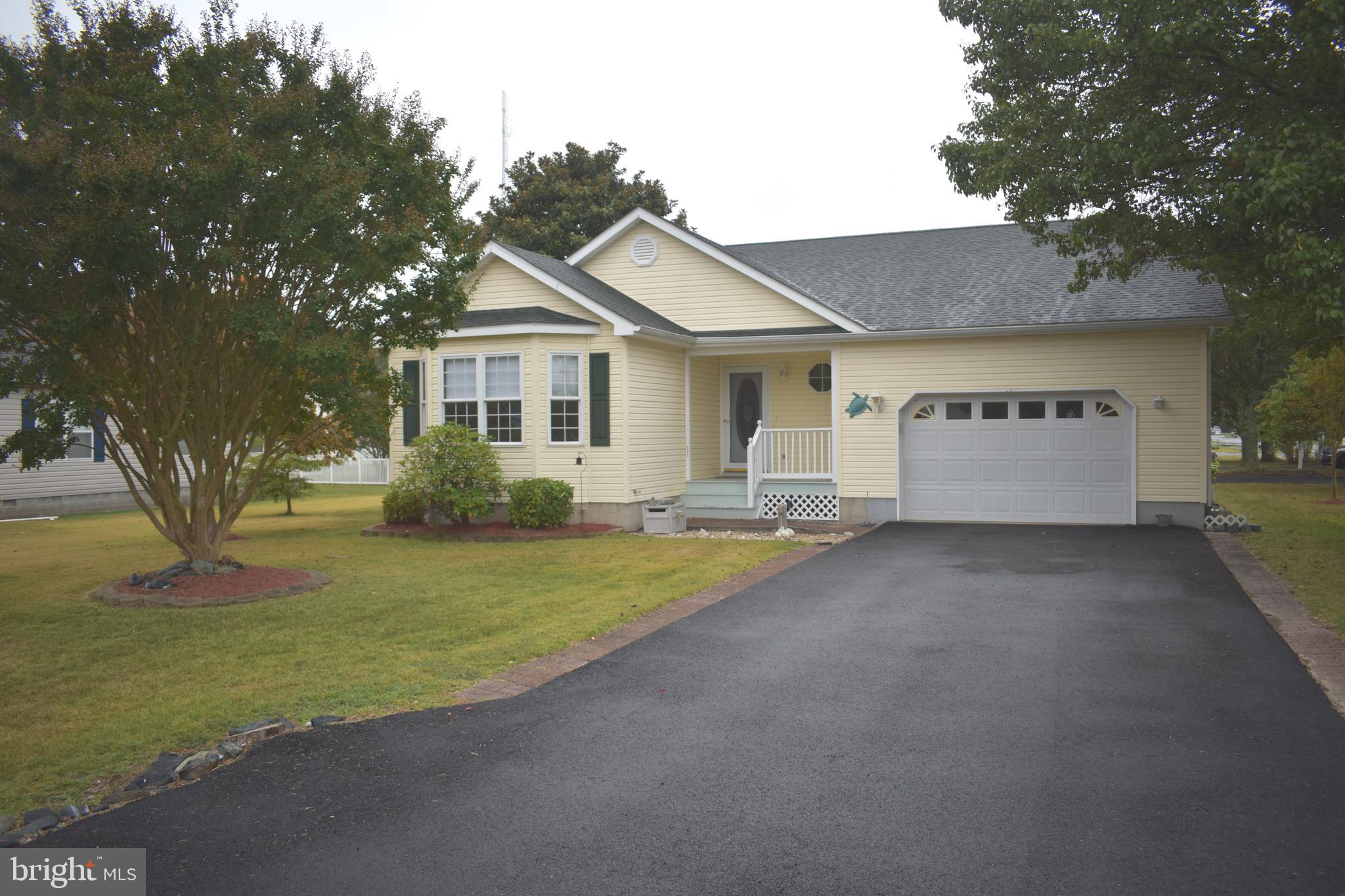 a view of a house with a yard and garage