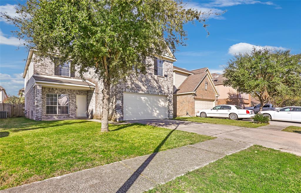 a view of a house with a yard and tree s