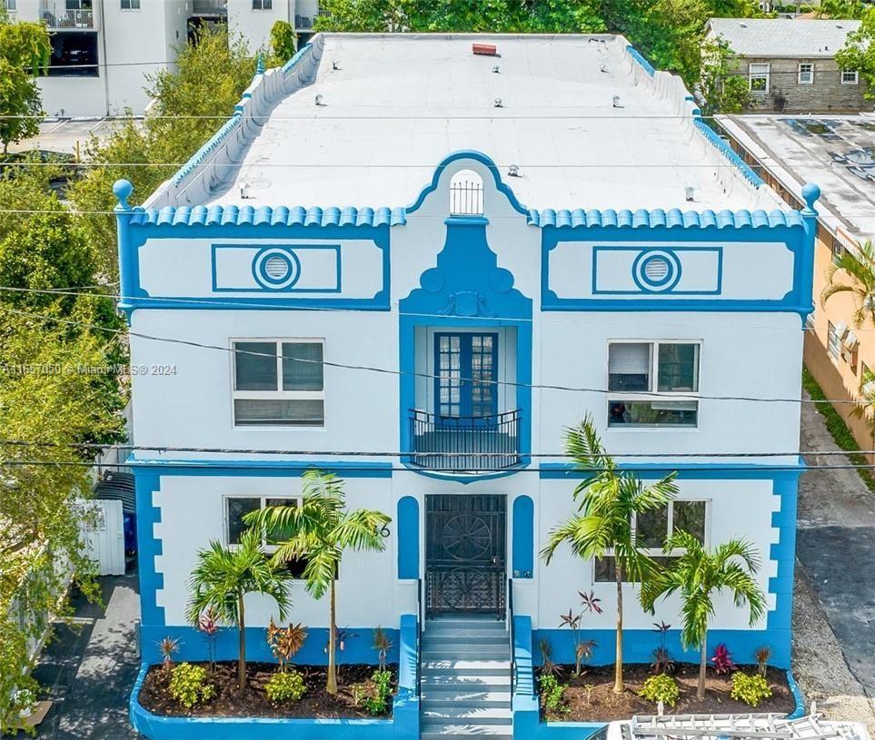 a front view of a building with potted plants