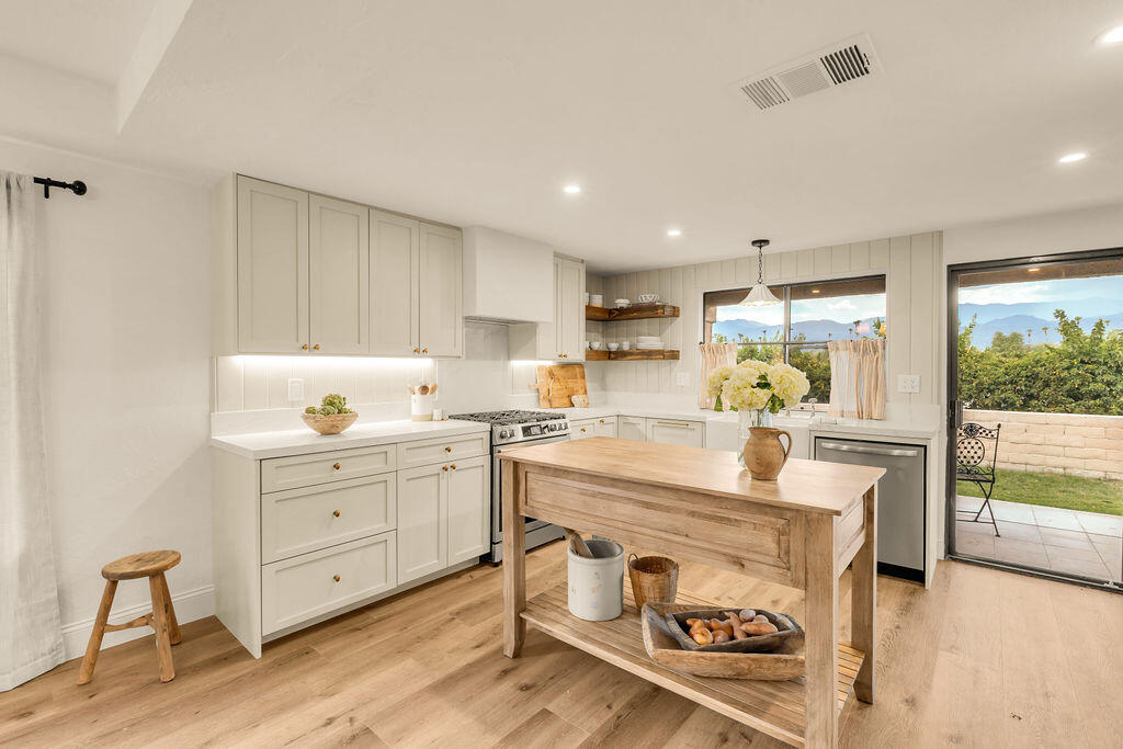 a kitchen with a stove a sink and a refrigerator