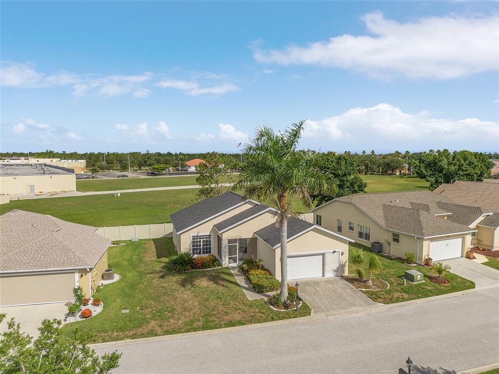 an aerial view of house with yard and ocean view