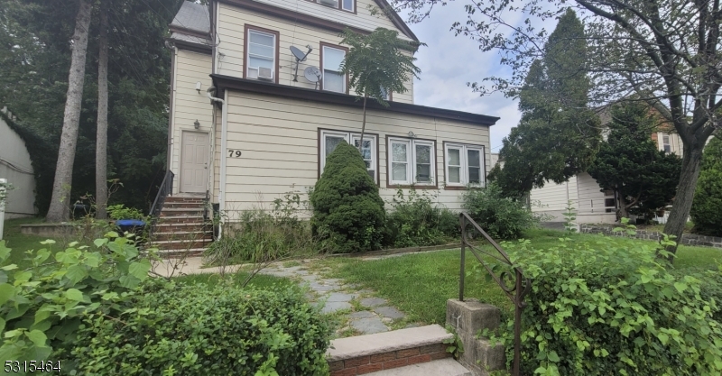 a view of a house with a yard and plants