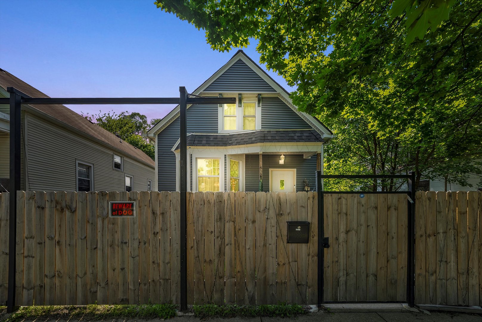 a front view of a house with wooden fence