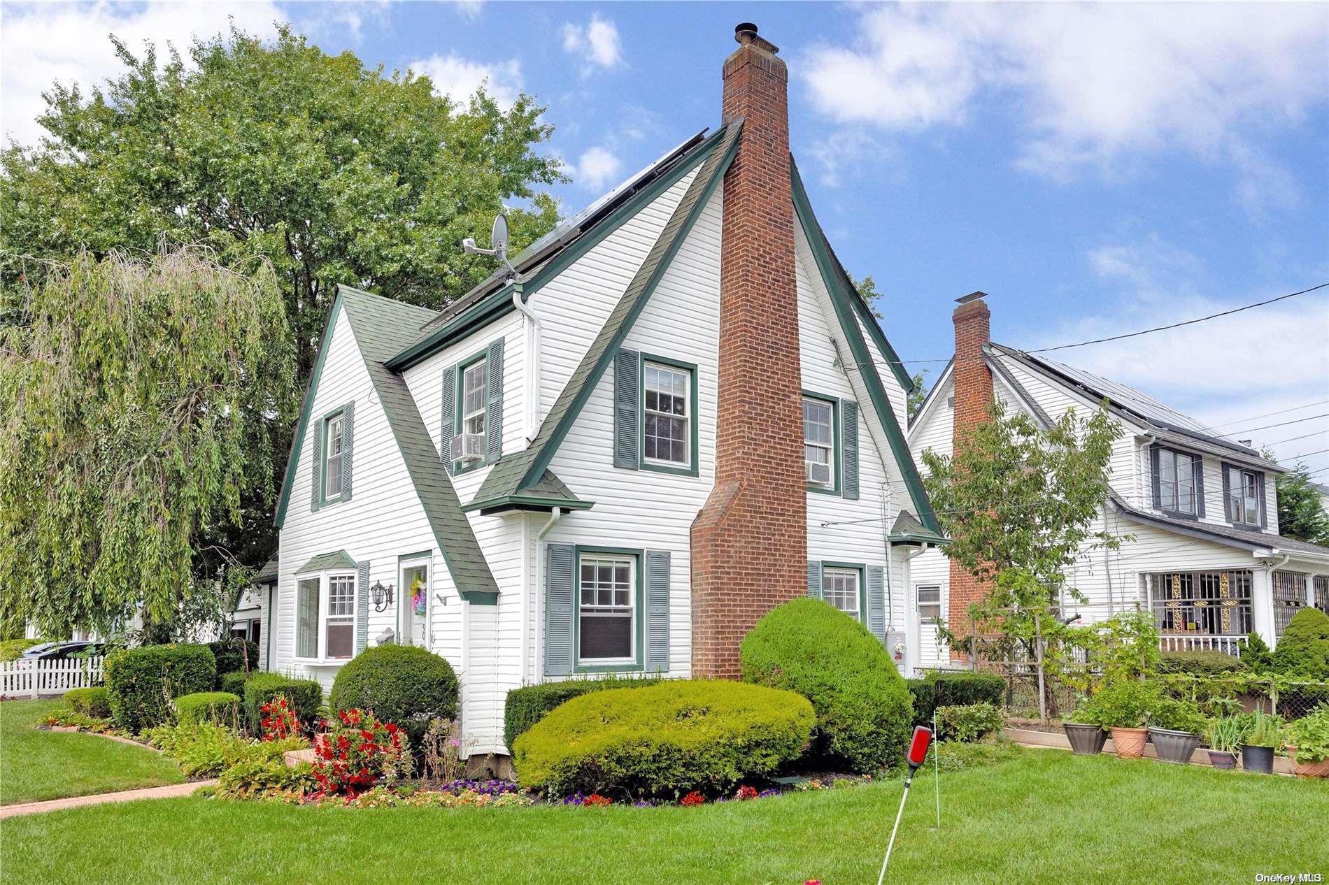 a front view of house with yard and green space