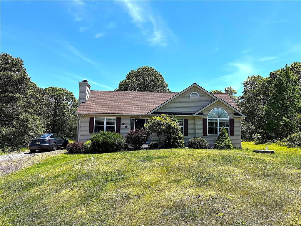 a front view of house with yard and green space