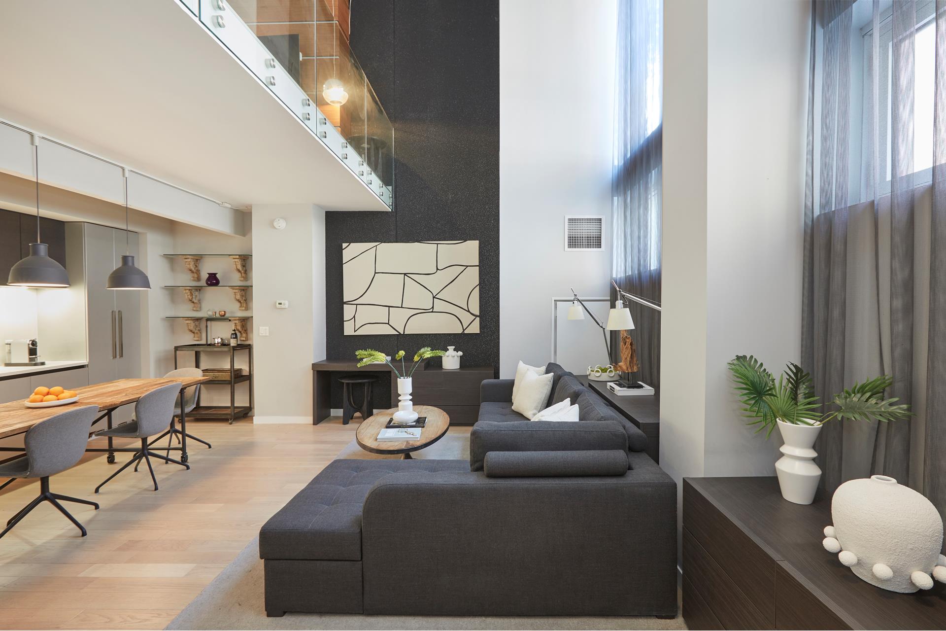 a living room with furniture and a potted plant