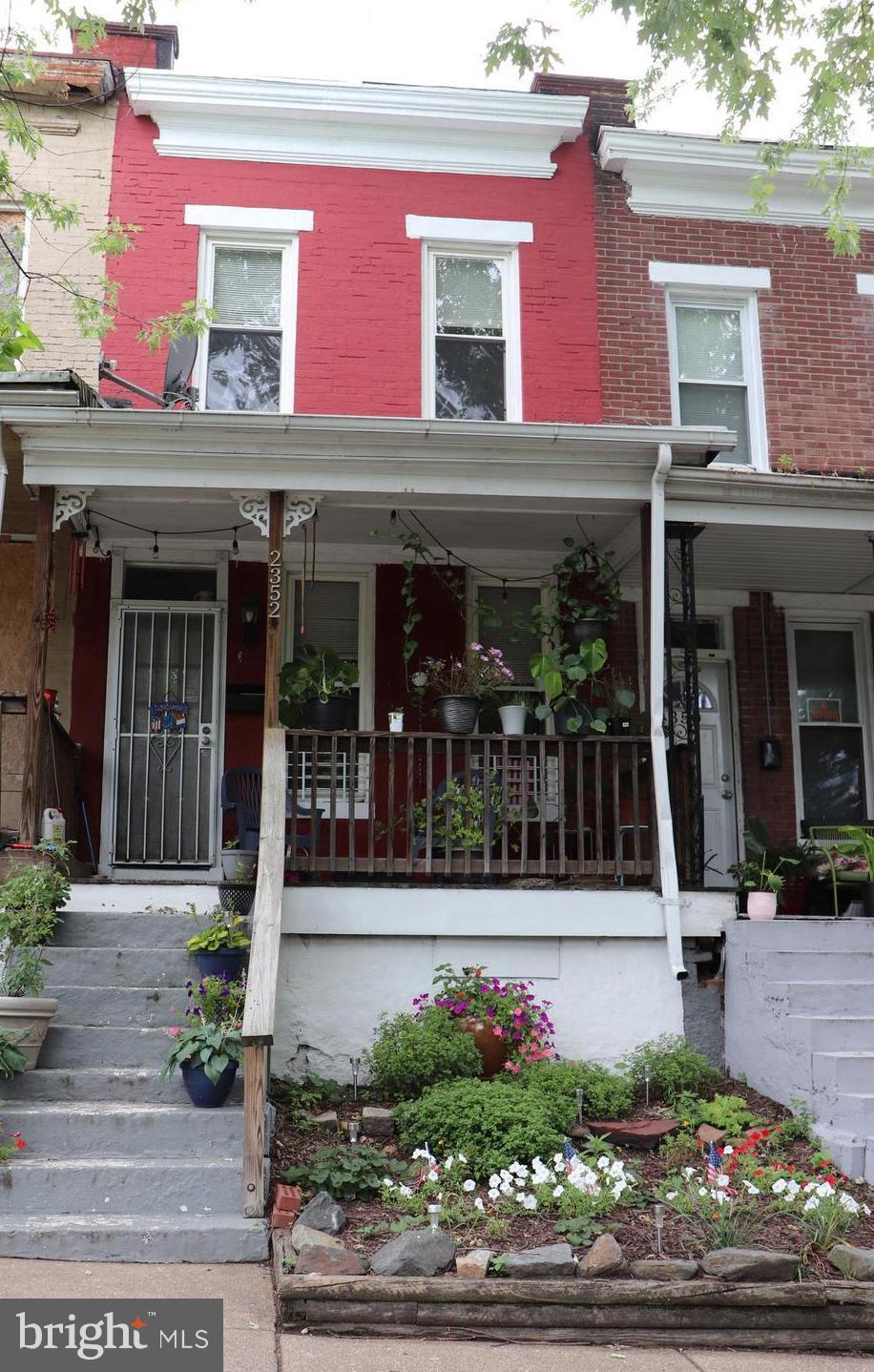 a view of brick building with potted plants