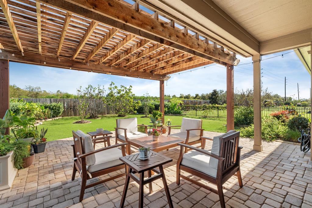 The covered patio, measuring 17 x 8, offers a perfect space for outdoor relaxation, and beyond it, you'll find a charming pergola adorned with lights, creating the ideal setting for evening entertainment. The stone pavers add a unique touch, making this area stand out as a true upgrade—something you won’t find in many other Del Webb properties. It’s an exceptional space for enjoying the outdoors in style!