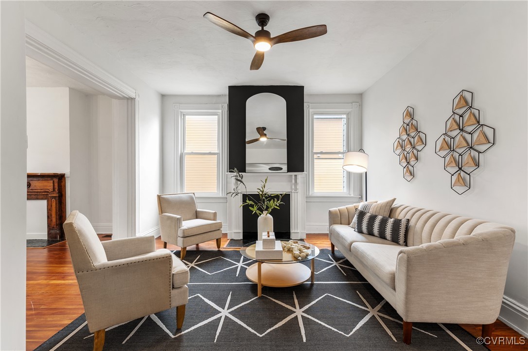 Living room with ceiling fan and hardwood / wood-s